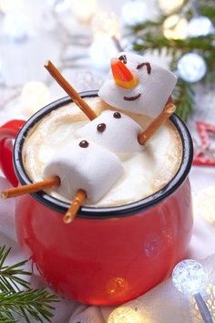 hot chocolate with marshmallows and snowman on top in a red mug