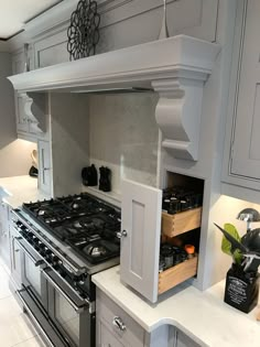 a kitchen with an oven, stove and cabinets in the middle of it's counter space