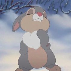 a cartoon rabbit standing in the snow with its eyes closed