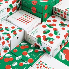 many boxes are stacked on top of each other with red and green polka dot designs