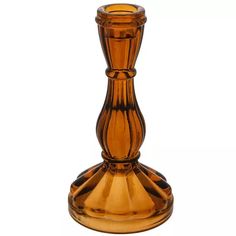 an orange glass vase sitting on top of a table