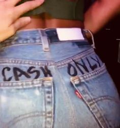 the back of someones jeans with cash only written on them and in their pockets