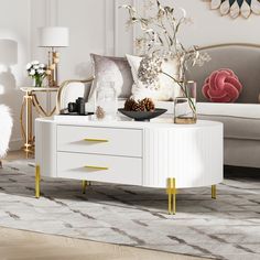 a living room with white furniture and gold accents on the walls, including a coffee table