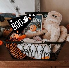 a basket filled with stuffed animals on top of a wooden table