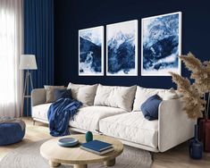 a living room with blue walls and white furniture