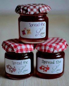 four jars of spread the love jam on a table