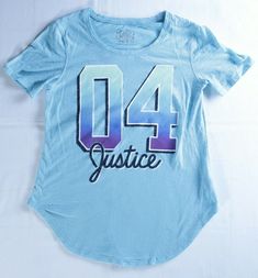 Justice graphic t-shirt, baby blue, short sleeve, glitter Justice script on the front - girl's size 10.  This cute shirt has a curved hem (great for leggings!) and slightly flared for comfortable fit.  Gorgeous sky blue, Justice 04 graphic on the front has glitter accent, this will be a favorite!   Measurements (laid flat - compare to item from your closet to ensure best fit): Chest: 14" Length: 22" Smoke & Pet Free Home 1383 SHIPPING: I will combine shipping. I will combine and ship in the most 90s Style Text Print Short Sleeve T-shirt, 90s Style Short Sleeve T-shirt With Text Print, Justice Outfits 2000s, 90s Style Blue T-shirt With Text Print, Justice Outfits, Spring List, Justice Fashion, Justice Clothes 2000s, 90s Blue T-shirt With Text Print