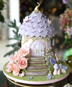 there is a cake that looks like a house with flowers on the outside and pink roses on the inside