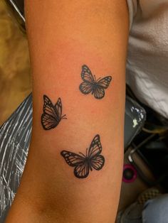 three butterflies tattoo on the arm