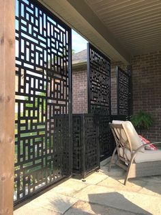 an outdoor living area with patio furniture and privacy screens