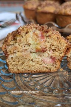 a muffin cut in half sitting on top of a glass plate