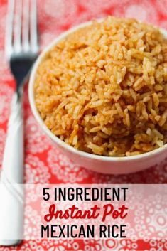 a white bowl filled with rice next to a fork and knife on top of a red table cloth