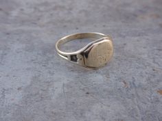 Art Deco Class Signet Ring made by Ostby Barton. This pretty lady has been very well loved and her engraved initials, FHS, are almost gone. She is 10k with a very pale aged yellow gold patina. She weighs 3g, is a size 6 3/4 and measures 9mm front center. She is highly collectible as she carries the Ostby Barton hallmark, OB10k . Sadly, one of the partners, Ostby, perished on the Titanic in 1912. All of my items are in previously loved, used condition so please review all photos closely and let m Antique Engraved Round Band Ring, Antique Engraved Ring Hallmarked, Antique 14k Stamped Jewelry For Ceremonial Occasions, Heirloom Stamped Signet Ring For Formal Occasions, Antique Stamped Yellow Gold Engraved Ring, Collectible Gold Stamped Ring, Formal Yellow Gold Ring, Antique Stamped Signet Ring For Formal Occasions, Antique Stamped Signet Ring For Wedding