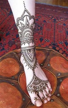 the foot is decorated with henna designs