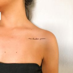 a woman with a tattoo on her left shoulder