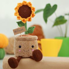 a stuffed sunflower sitting on top of a piece of cardboard