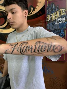 a man with a tattoo on his arm that says havanas in cursive writing