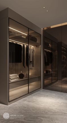 an empty walk in closet with clothes on hangers and other items hanging from the walls