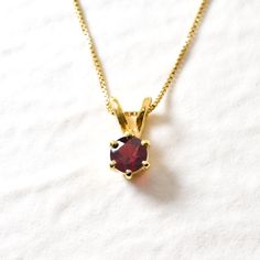 Gold Garnet Pendant set with Natural Garnet in a flawless diamond cut & clarify, at 5mm. Gold Vermeil ☞ 18k Gold Plating on top of Solid 925 Sterling Silver. Matching Earrings & Matching Ring - please ask me January Birthstone - Genuine & Natural Stone ❀  ❀ Each Natural Gem is unique & will have Slight variations from the product pictures "no two Natural Stones are alike" Details :  ♥ Each item comes in a cute GIFT BOX ✓  ♥ GUARANTEE on the materials ✓ ♥ Natural Garnet - perfect diamond cut & natural color ✓ ♥ Solid 925 Sterling Silver - Silver Hallmark on each piece ♕ ♥ The pendant is plated with 18k Gold (the thickest plating - 3 Micron) ✓ ♥ Measurements: Garnet at 5mm diameter ✓ ♥ Each stone is set professionally - Real Jewelry artisan work ♕ ♥ More Beautiful jewellery on www.etsy.com/s Classic Round Pendant Birthstone Necklace For Gift, Classic Birthstone Necklace With Round Stone For Gifting, Classic Birthstone Necklace With Round Pendant As Gift, Classic Diamond Cut Birthstone Necklace As A Gift, Birthstone Necklace With Brilliant Cut Round Pendant, Gift Diamond Cut Birthstone Necklace, Brilliant Cut Birthstone Necklace With Round Pendant, Gift Birthstone Necklace With Brilliant Cut Round Pendant, Gift Birthstone Necklace With Diamond Cut