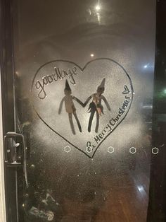 two people holding hands in front of a frosted glass door with the word goodbye written on it