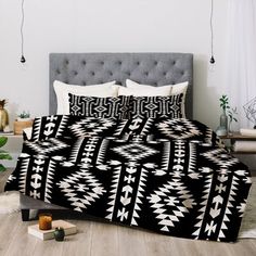 a bed with a black and white pattern on it