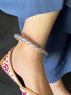 RESTOCKED ♥️ Elevate your ankle adornment with our premium Antique Ankle Kada, a testament to fine craftsmanship and timeless elegance. Meticulously handcrafted from pure 925 silver, this exquisite piece is a blend of heritage and contemporary sophistication. Its intricate design exudes charm and complements any style, from traditional to modern. Whether it's a special occasion or everyday wear, this Anklet Kada will add a touch of grace and refinement to your ensemble. Embrace the beauty of tradition and craftsmanship with this stunning piece that celebrates the artistry of silver. This is free size and is stretchable, can be worn easily. Weight: 43 grams for single piece. Inner Diameter: 8 cms Elegant Handmade Festive Anklets, Elegant Oxidized Anklets For Festivals, Festive Sterling Silver Anklets, Ceremonial Oxidized Bracelets, Elegant Handmade Sterling Silver Anklets, Oxidized Finish Anklets For Wedding, Elegant Adjustable Oxidized Anklets, Elegant Adjustable Anklets With Oxidized Finish, Elegant Adjustable Oxidized Finish Anklets