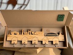 a wooden model of a city in a box