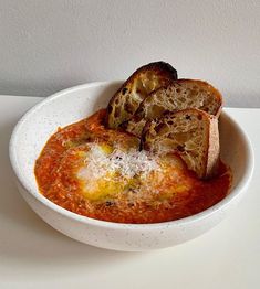 a white bowl filled with food on top of a table