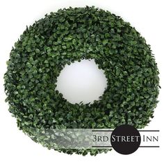 a green wreath with the words 3rd street inn in front of it and an image of a