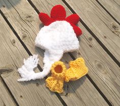 there is a knitted chicken hat and booties on the ground