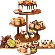 three tiered trays filled with different types of cakes and pastries on wooden platters