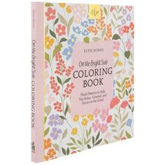 an adult coloring book with flowers on the front and back cover, in white background