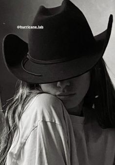 black and white photograph of a woman wearing a cowboy hat