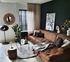 a living room filled with lots of furniture next to a large window covered in curtains