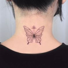 a woman's neck with a small butterfly tattoo on the back of her neck