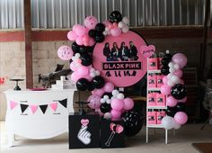 pink and black balloons are on display in front of a sign that says blax pink