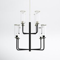 a black chandelier with four glass tubes hanging from it's center rod