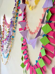 colorful paper garlands are hanging on the wall