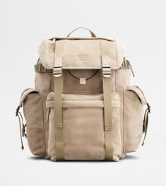 Backpack in suede, with handle strap and adjustable shoulder straps. Closed with flap and branded metal buckles, it features a flat upper pocket and wide zipped front pocket. The sides come with practical flap pockets, while the interior comes with a drawstring with branded slider. A refined synthesis of artisanal taste and functionality. Luxury Leather Backpack For Outdoor, Designer Leather Bag With Pockets, Designer Travel Shoulder Bag With Pockets, Outdoor Leather Bag With Detachable Strap, Luxury Leather Bags With Multiple Pockets, Casual Shoulder Bag With Buckle Closure For Travel, Casual Travel Shoulder Bag With Buckle Closure, Everyday Backpack With Buckle Closure, Designer Suede Shoulder Bag For Travel