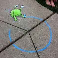 a child's feet standing next to a sidewalk with blue chalk drawings on it