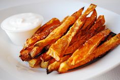 some fries on a white plate with dip