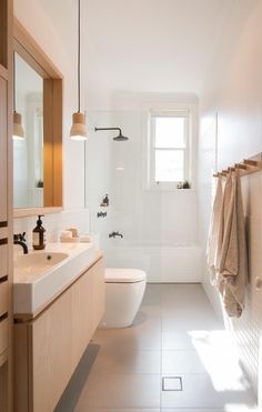 a bathroom with a sink, toilet and bathtub next to a window in it