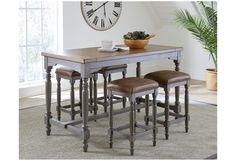 a dining table with four stools and a clock on the wall in the background