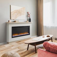 a living room with a couch, coffee table and fire place in front of the fireplace