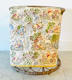 an upholstered chair with winnie the pooh fabric on it's back