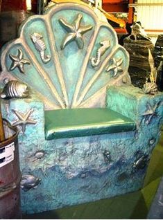 a chair made out of sea shells on display