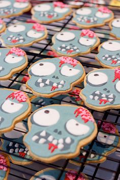 some decorated cookies are sitting on a cooling rack