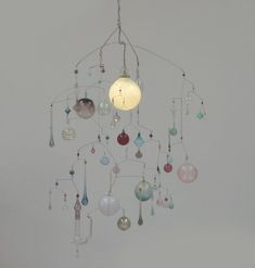 a wind chime hanging from the ceiling with lots of different colored glass beads on it