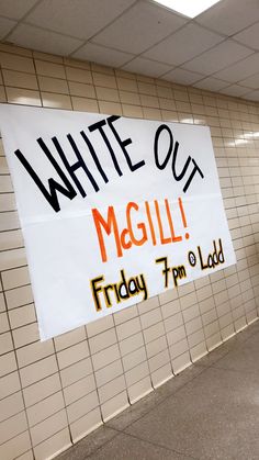 a white out sign hanging from the side of a wall next to a subway station