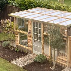 a small wooden structure with glass doors and windows